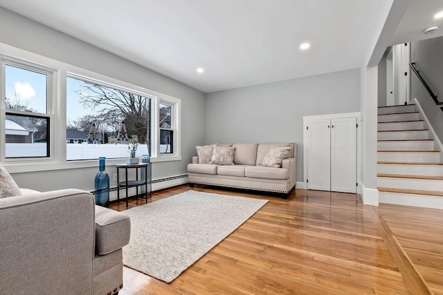 living room featuring hardwood / wood-style floors and a baseboard heating unit