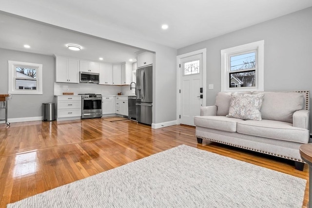 living room with hardwood / wood-style flooring and a wealth of natural light