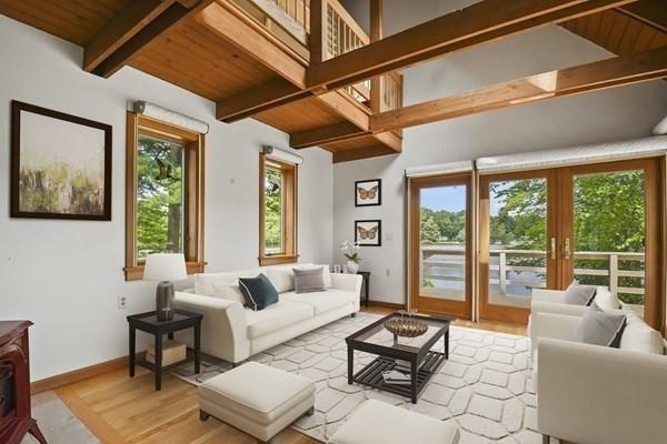living area featuring light wood-style flooring, baseboards, beam ceiling, french doors, and wood ceiling