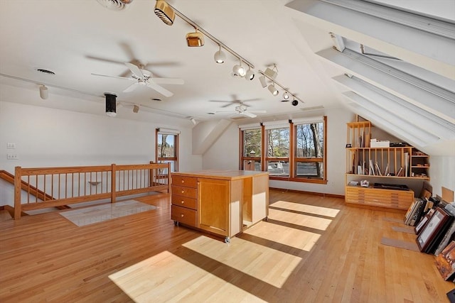 additional living space featuring ceiling fan, vaulted ceiling, and light wood-style floors