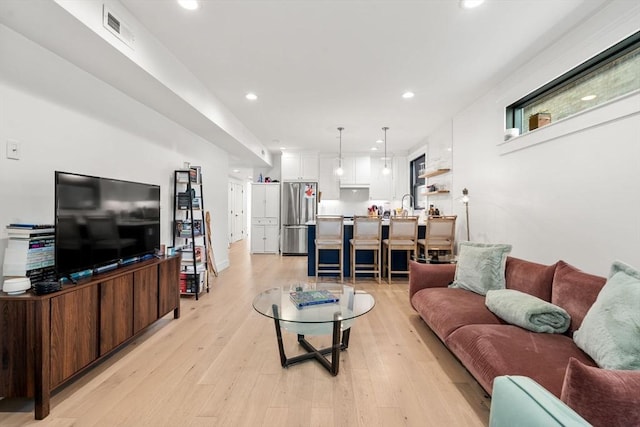 331 Chelsea St Unit 1, Boston, MA 02128 - living room with light wood finished floors and recessed lighting