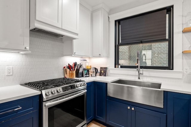 331 Chelsea St Unit 1, Boston, MA 02128 - kitchen featuring stainless steel gas stove, blue cabinetry, a sink, light countertops, and tasteful backsplash