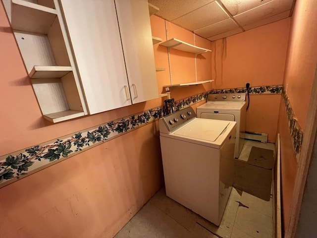 laundry area featuring a baseboard heating unit, independent washer and dryer, and cabinet space