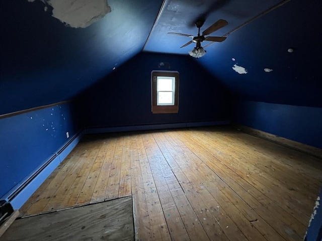 additional living space featuring ceiling fan, vaulted ceiling, and hardwood / wood-style floors