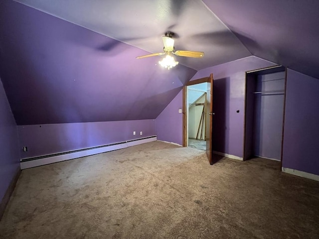 additional living space with lofted ceiling, a baseboard heating unit, carpet flooring, a ceiling fan, and baseboards