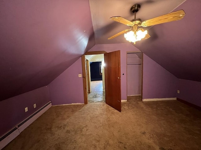 additional living space featuring ceiling fan, a baseboard heating unit, carpet floors, baseboards, and vaulted ceiling