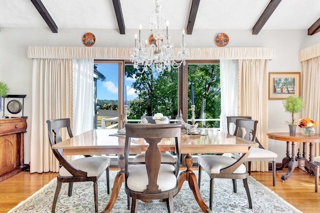 dining space featuring light hardwood / wood-style flooring, beam ceiling, and plenty of natural light