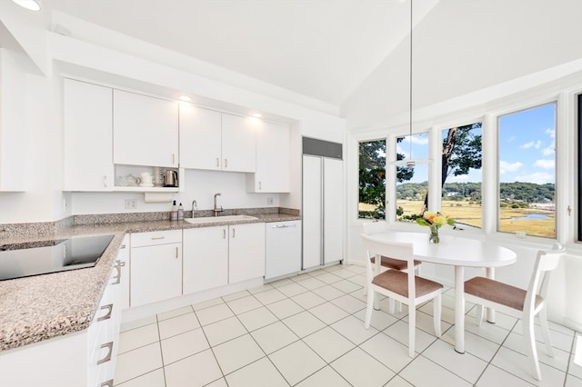 kitchen with light tile patterned flooring, white cabinets, white dishwasher, lofted ceiling, and sink