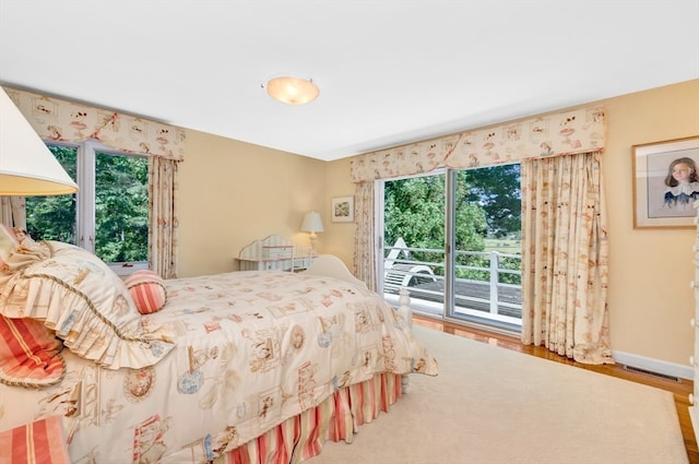 bedroom featuring hardwood / wood-style flooring and access to exterior