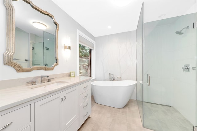 bathroom featuring independent shower and bath and vanity