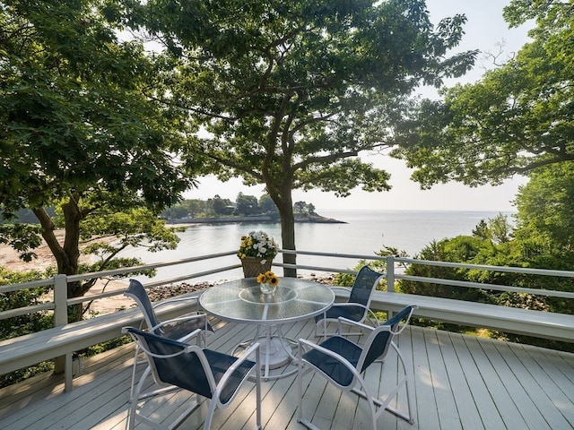 wooden terrace featuring a water view