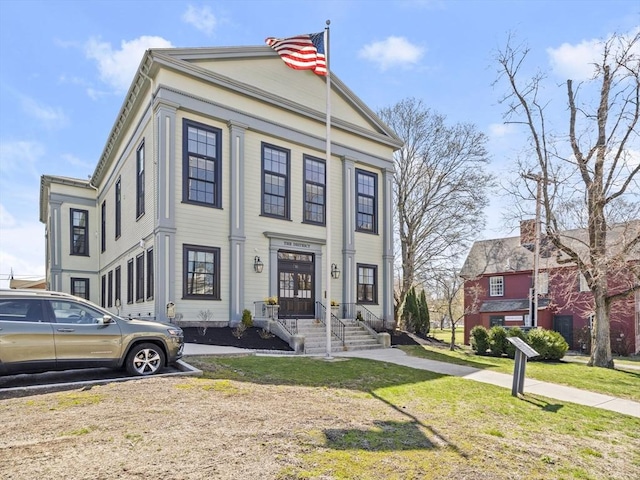 greek revival house with a front yard
