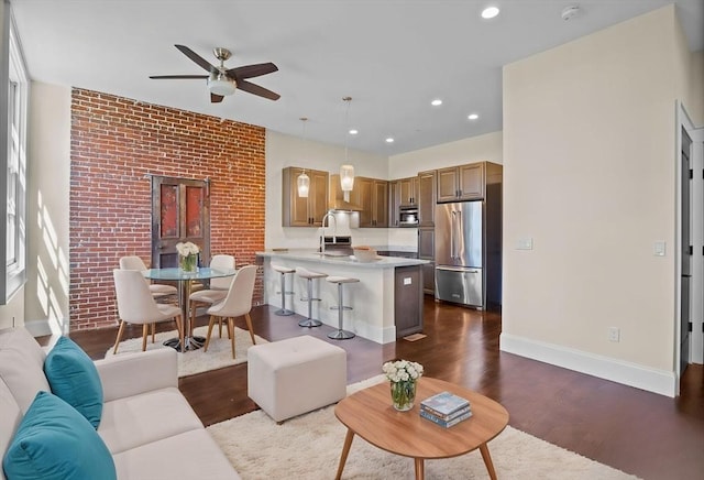 living room with baseboards, a ceiling fan, dark wood-type flooring, and recessed lighting