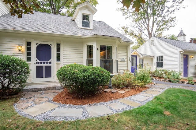 view of exterior entry with a yard