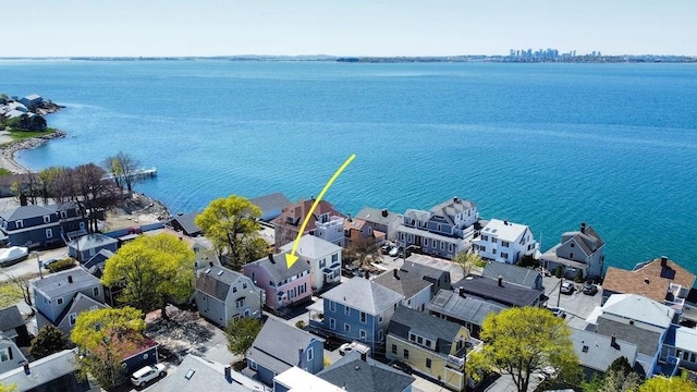 birds eye view of property with a water view and a residential view