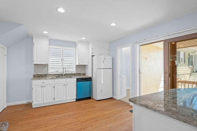 kitchen with a sink, light wood finished floors, freestanding refrigerator, white cabinetry, and dishwashing machine
