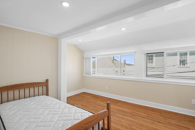 bedroom with baseboards, recessed lighting, and wood finished floors