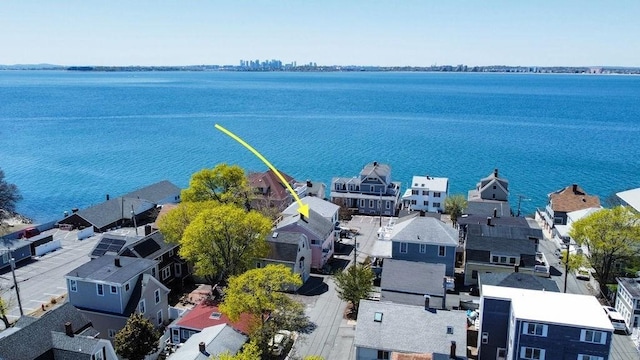 drone / aerial view with a water view and a residential view