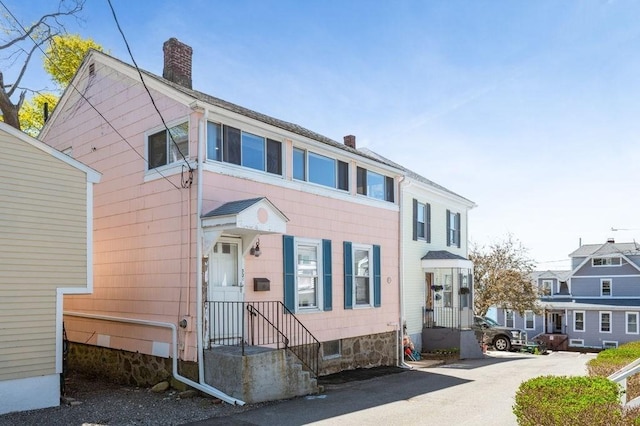 view of front of home featuring a chimney