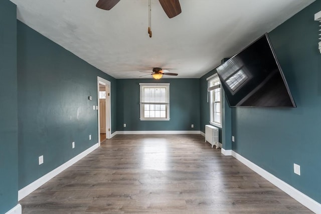 263 Jefferson Ave, Salem, MA 01970 - empty room featuring ceiling fan, radiator, and dark wood-style flooring