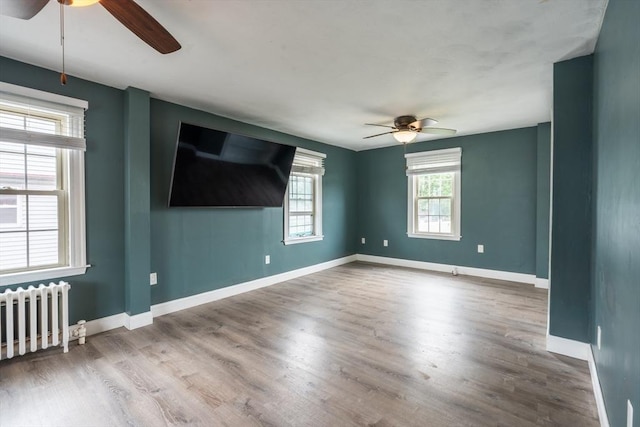 263 Jefferson Ave, Salem, MA 01970 - empty room featuring ceiling fan, radiator heating unit, and wood finished floors