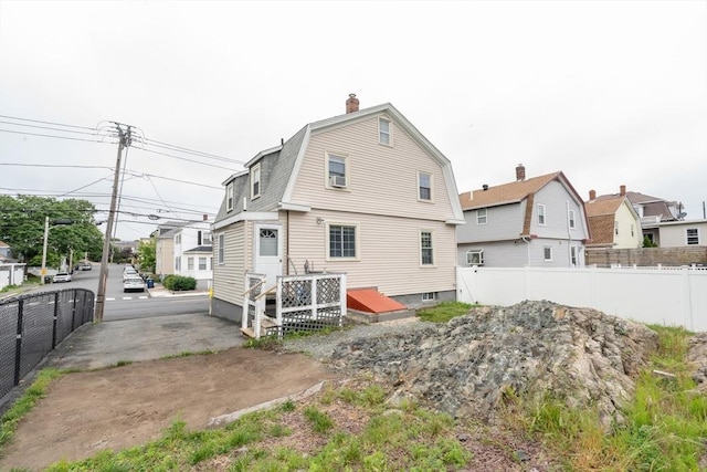 263 Jefferson Ave, Salem, MA 01970 - back of property with a chimney, a gambrel roof, and cooling unit