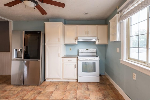 263 Jefferson Ave, Salem, MA 01970 - kitchen with white electric stove, stainless steel fridge, under cabinet range hood, a ceiling fan, and white cabinetry