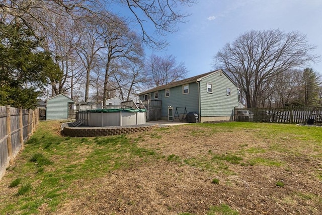 view of yard with a fenced in pool and fence