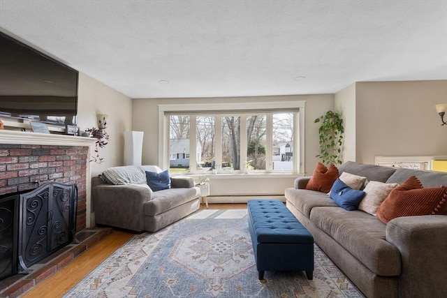 living area with a baseboard heating unit and wood finished floors