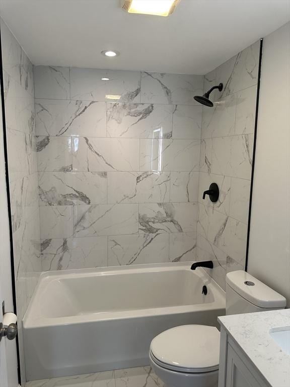 bathroom featuring marble finish floor, vanity, toilet, and bathing tub / shower combination