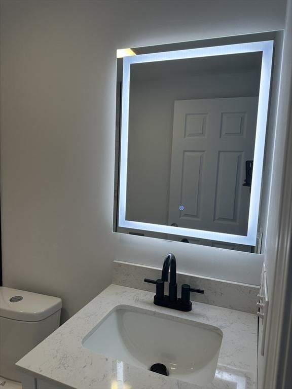 bathroom with toilet and vanity