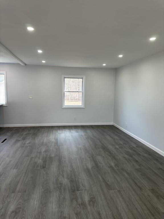 unfurnished room featuring recessed lighting, baseboards, and dark wood finished floors