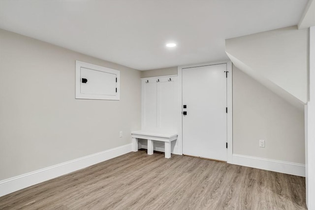 mudroom featuring light wood-style flooring and baseboards