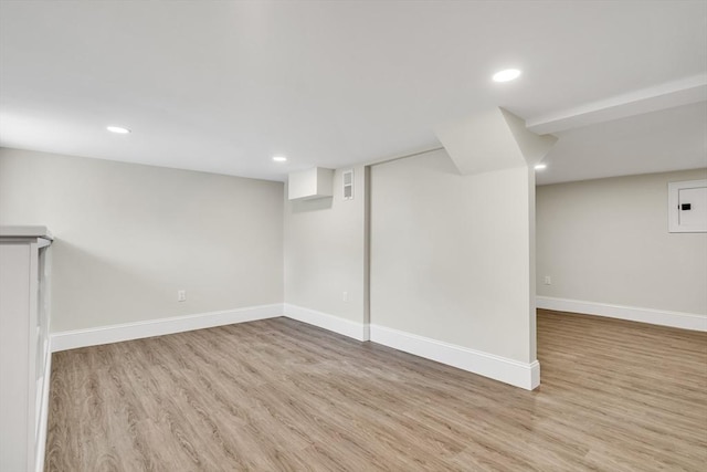 finished basement with baseboards, wood finished floors, and recessed lighting