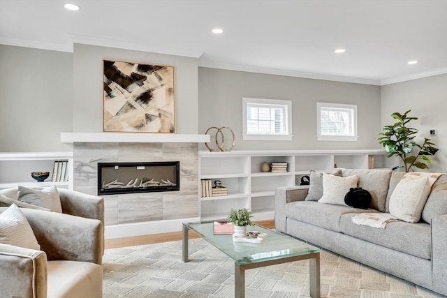 living area featuring recessed lighting, crown molding, a tiled fireplace, and wood finished floors