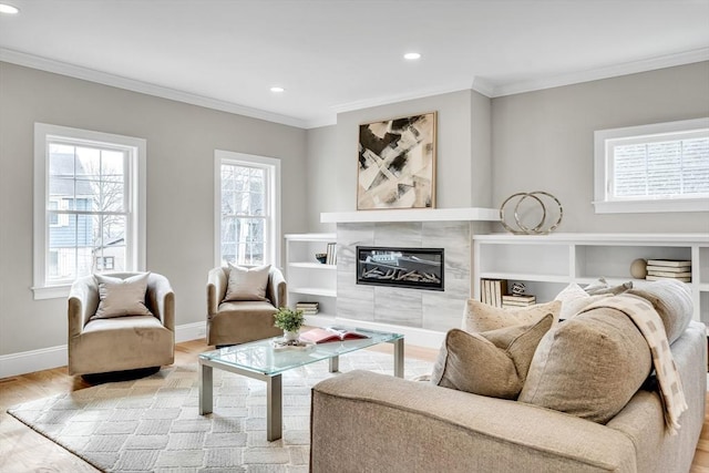 living area featuring crown molding, light wood finished floors, recessed lighting, a tile fireplace, and baseboards