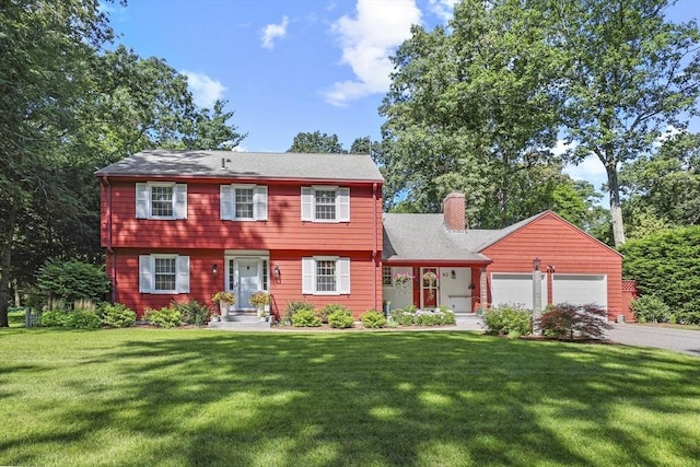 82 Knollwood Dr, Longmeadow, MA 01106 - colonial house featuring a chimney, an attached garage, a front lawn, and asphalt driveway
