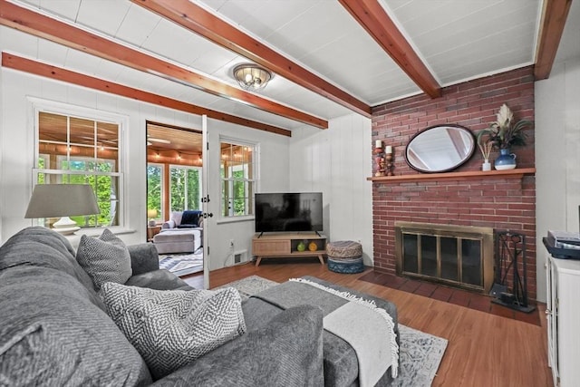 82 Knollwood Dr, Longmeadow, MA 01106 - living area featuring wood finished floors, beam ceiling, and a brick fireplace