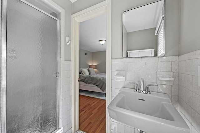 82 Knollwood Dr, Longmeadow, MA 01106 - ensuite bathroom featuring a stall shower, wood finished floors, and tile walls