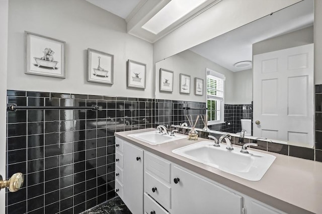 82 Knollwood Dr, Longmeadow, MA 01106 - bathroom featuring tile walls, double vanity, and a wainscoted wall