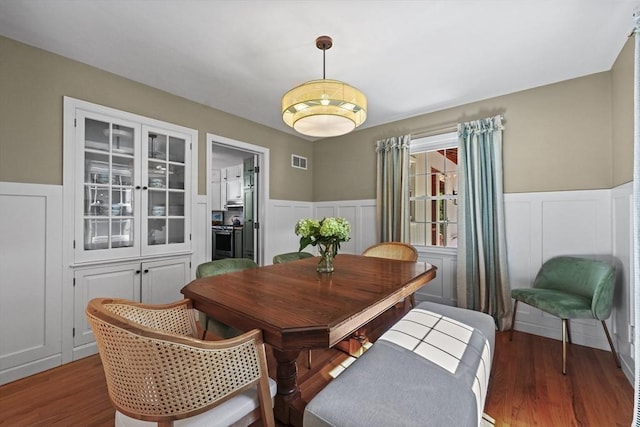 82 Knollwood Dr, Longmeadow, MA 01106 - dining space with a wainscoted wall, a decorative wall, and wood finished floors