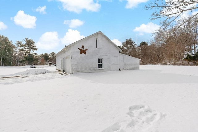 view of snow covered back of property