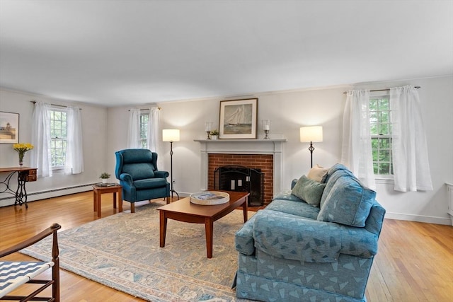 1 Emerson Dr, Acton, MA 01720 - living area featuring wood finished floors, a baseboard radiator, a brick fireplace, crown molding, and baseboards
