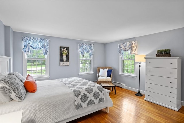 1 Emerson Dr, Acton, MA 01720 - bedroom featuring a baseboard radiator, multiple windows, wood finished floors, and baseboards