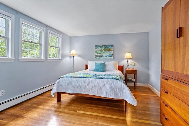 1 Emerson Dr, Acton, MA 01720 - bedroom featuring a baseboard radiator, wood finished floors, and baseboards
