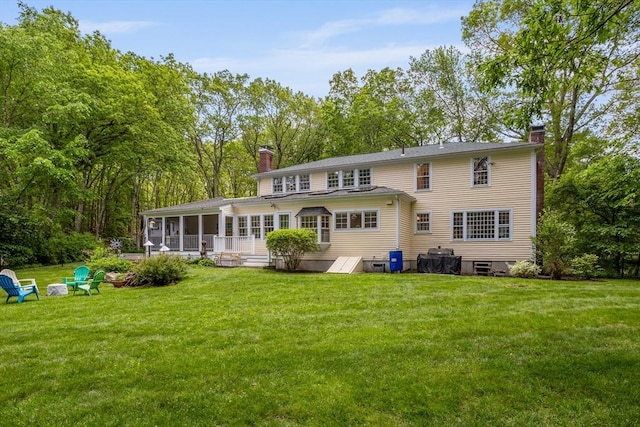 1 Emerson Dr, Acton, MA 01720 - back of property with a chimney, a sunroom, and a lawn
