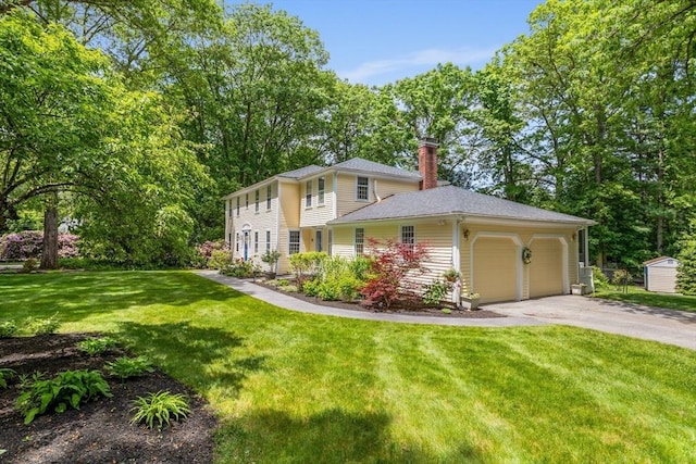 1 Emerson Dr, Acton, MA 01720 - view of front of property featuring a chimney, an attached garage, driveway, and a front lawn
