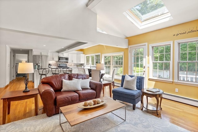 1 Emerson Dr, Acton, MA 01720 - living area featuring a skylight, light wood-type flooring, plenty of natural light, and vaulted ceiling