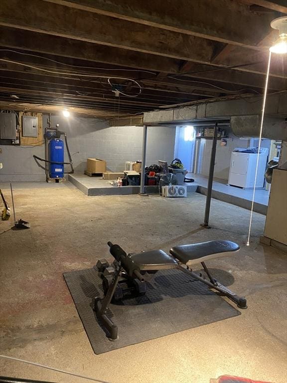 workout room with washer and clothes dryer and electric panel