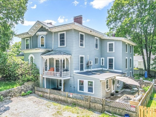 1 Nelson St Unit C, Upton, MA 01568 - rear view of property featuring a chimney, a fenced backyard, and a patio area